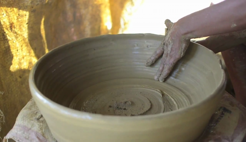CLAY POT takes shape on a potter's wheel. CLAY POT takes shape on a potter's wheel.